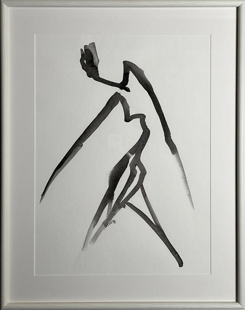 Framed black and white abstract artwork on a white wall