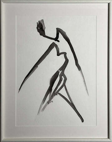 Framed black and white abstract artwork on a white wall
